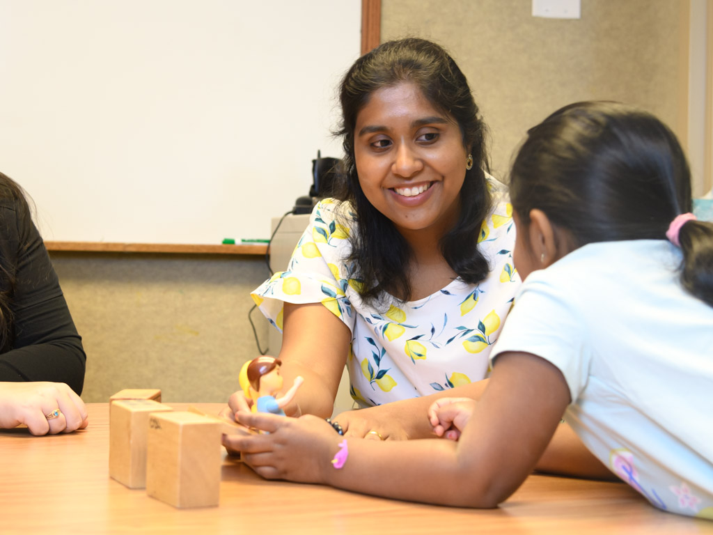 Faculty working with kids