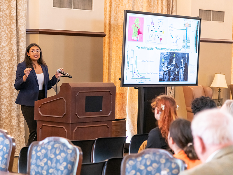 integrity_excellence.jpg Student presenting at lecturn.