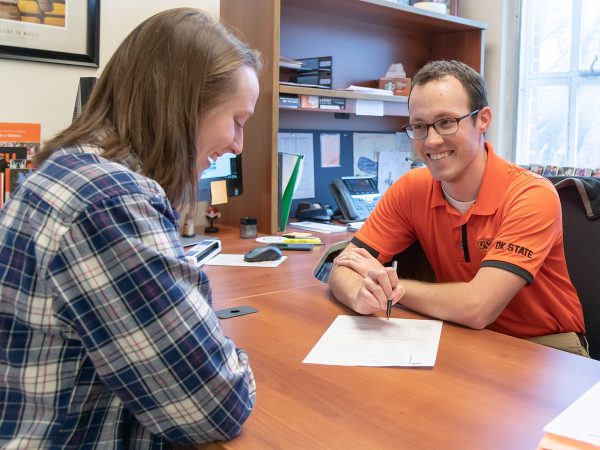 Male advisor speaking with a female student