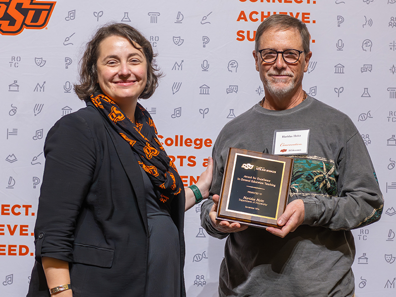 Award for Excellenct in General Education Teaching Haridus Heitz receiving his award on stage with Dean Cro