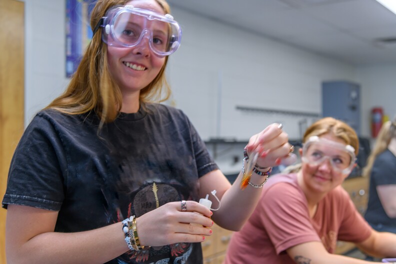 chemistry student holding test tube