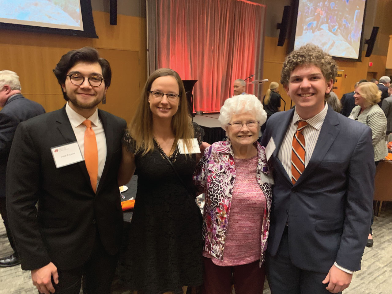 3 students and a donor at an awards banquet