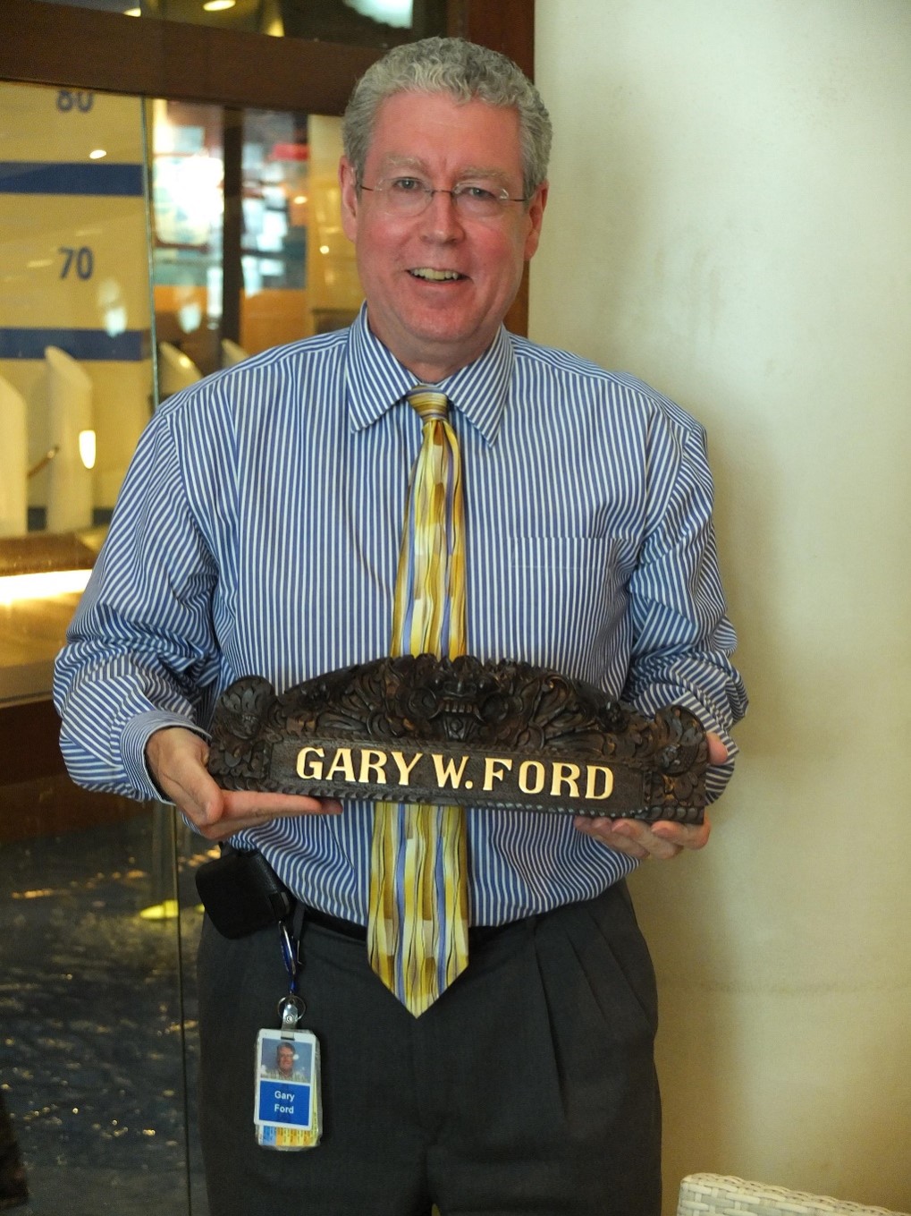 Mr. Gary Ford holding an award with his name on it.