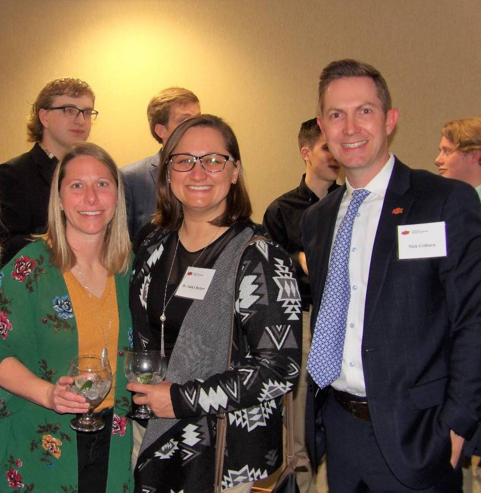 Ms. Maddy Foster, Dr. Ashley Burkett, and Mr. Nick Colburn smiling for a photo together.