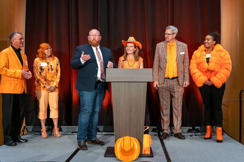 Brandon Spencer asks the audience to vote for 2nd and 3rd place for rock the orange award.