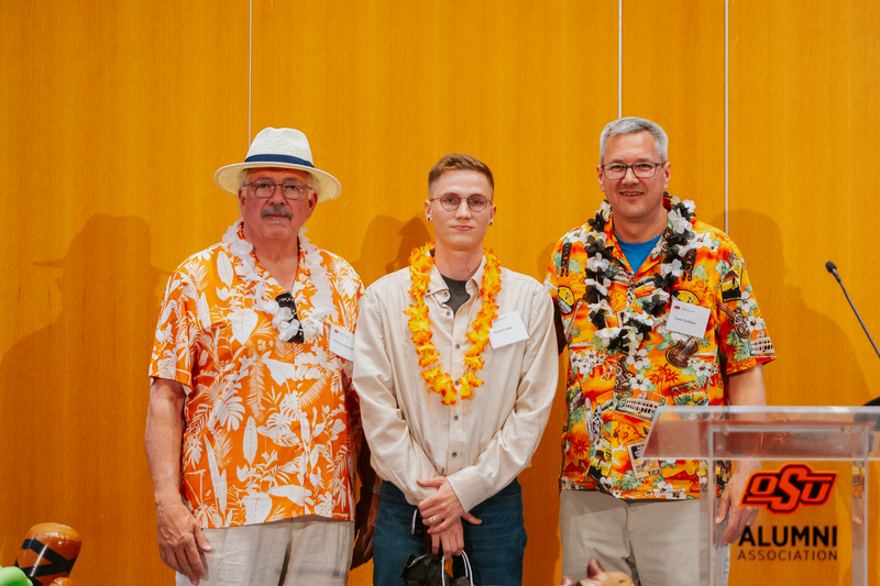 Mike Kuykendall and Todd Halihan giving Steven Cotton his Oustanding Senior Award.