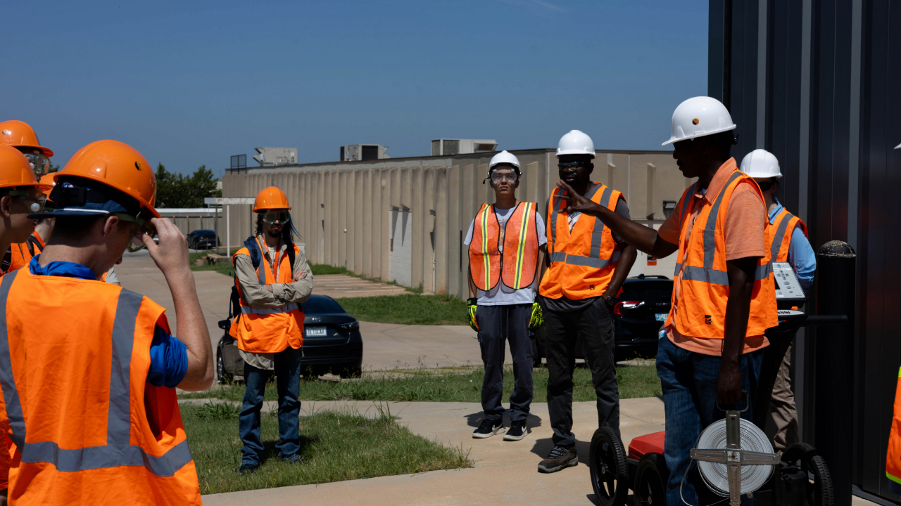 Dr. Andrew Katumwehe taking GEO-Rex campers out into the field, to get some hands-on learning.