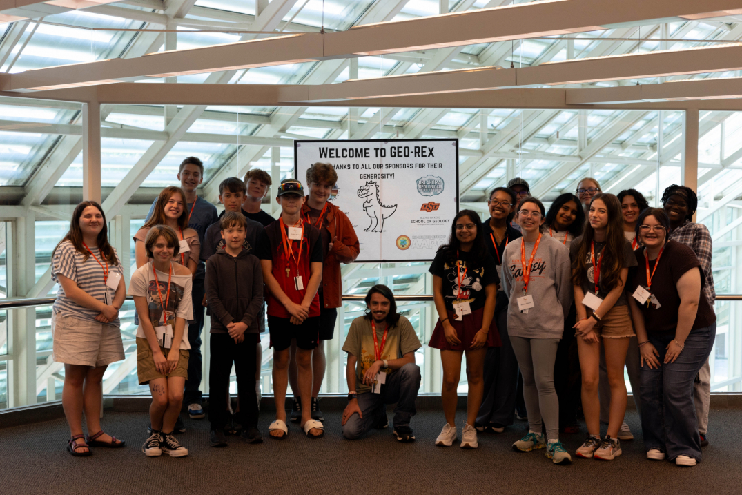 GEO-Rex campers taking a group picture with the donors poster as a thank you to the donors.
