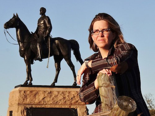 woman posing by statue