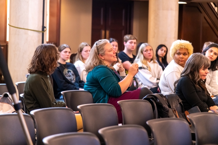 A seated audience of mostly women. 