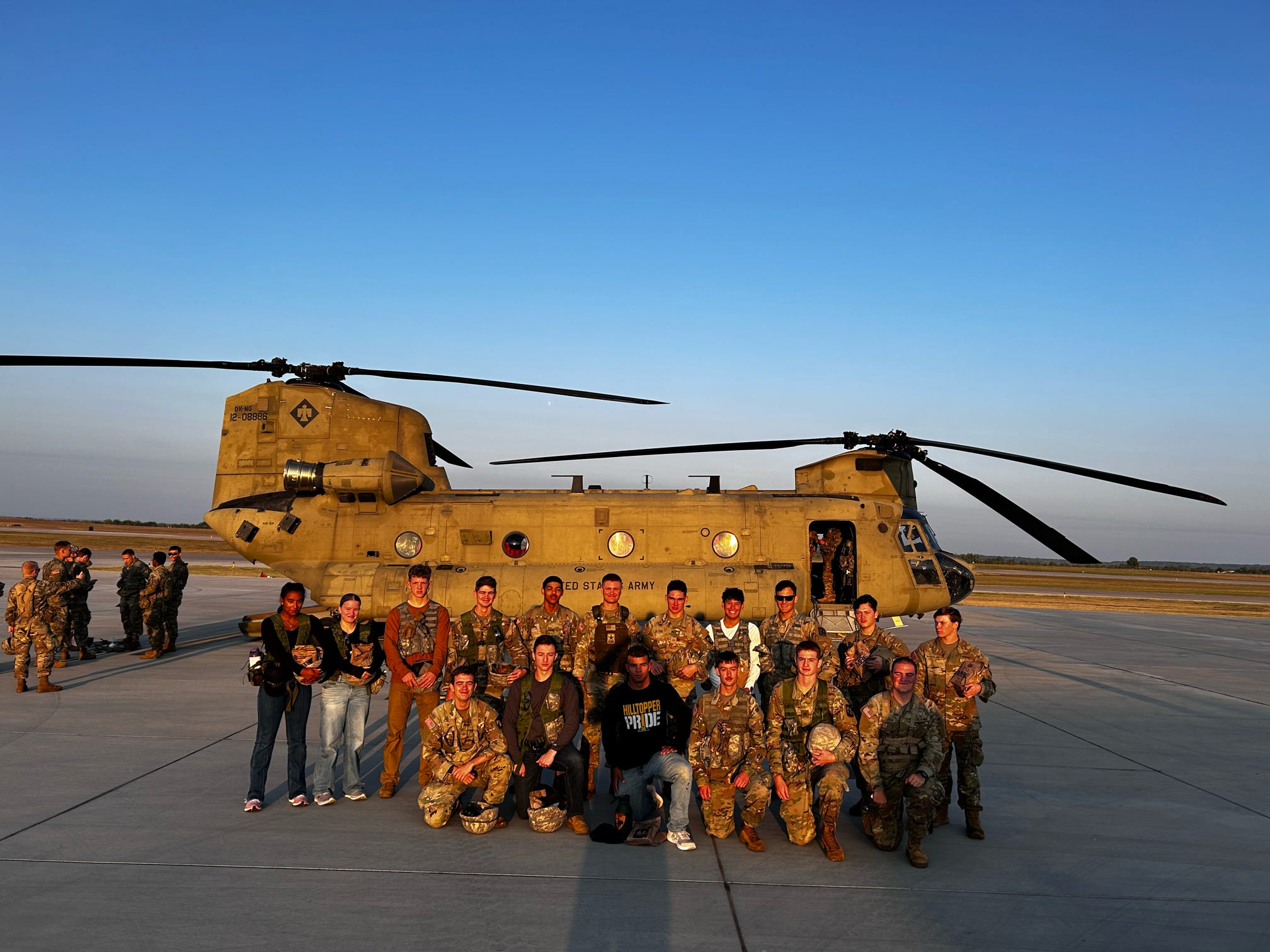 cadets posing in front of helicopter cadets posing in front of helicopter