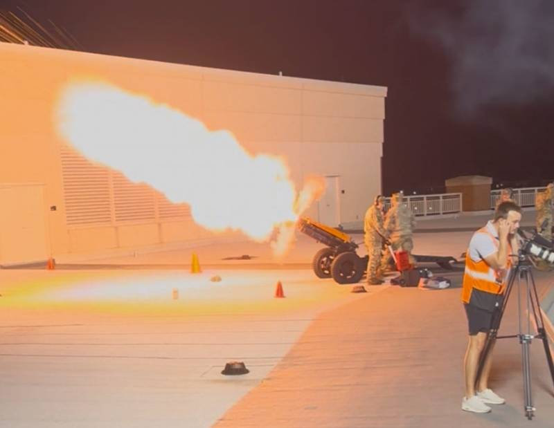 a cadet fires a canon at a football game a cadet fires a canon at a football game