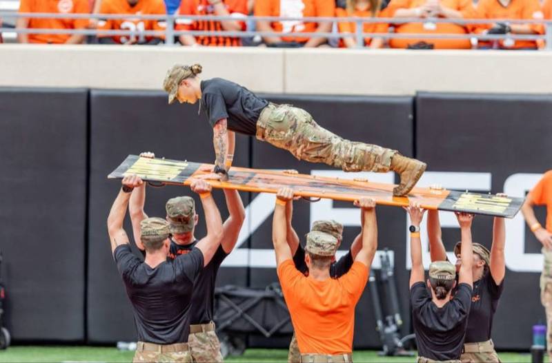 a cadet does pushups at a football game a cadet does pushups at a football game