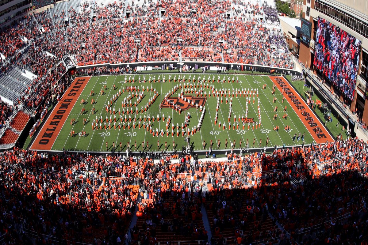 Cowboy Marching Band on the field in the OSU logo Cowboy Marching Band on the field in the OSU logo