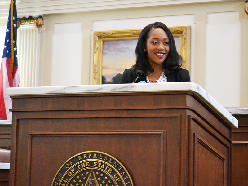 female student at podium in the state capital