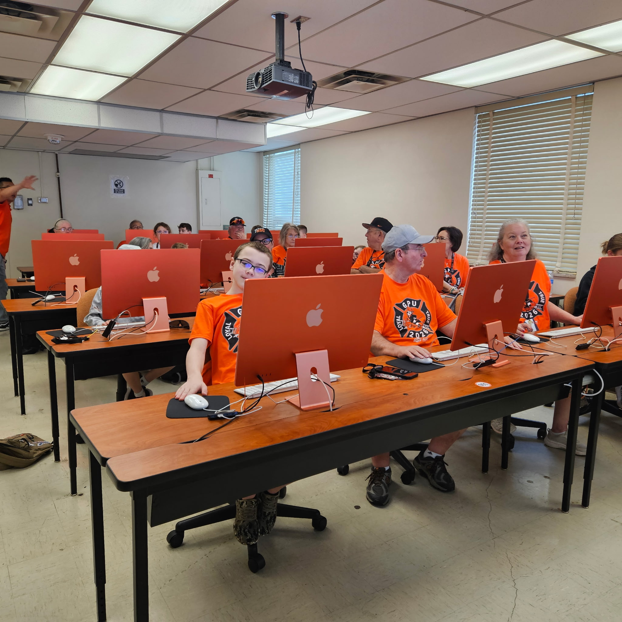 Classroom computer lab with students working at desktop computers during class.