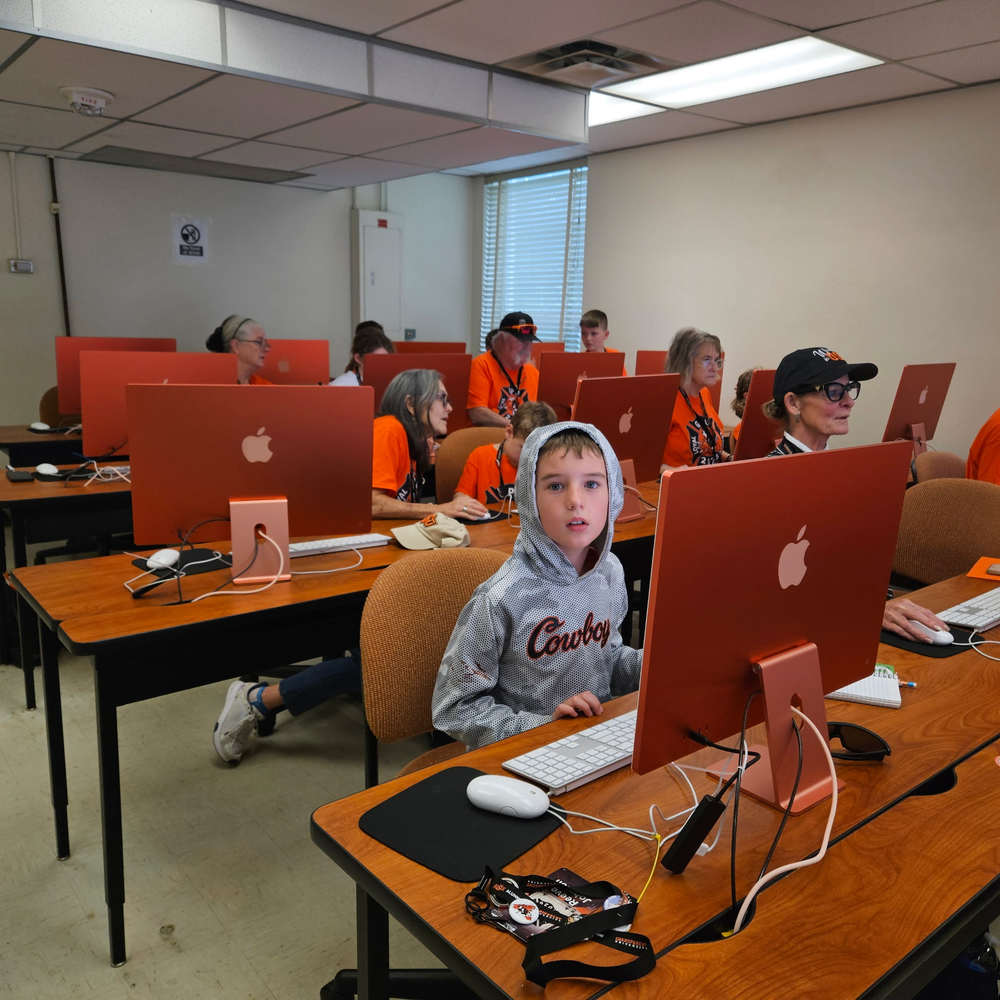 Classroom computer lab with students working at desktop computers during class.
