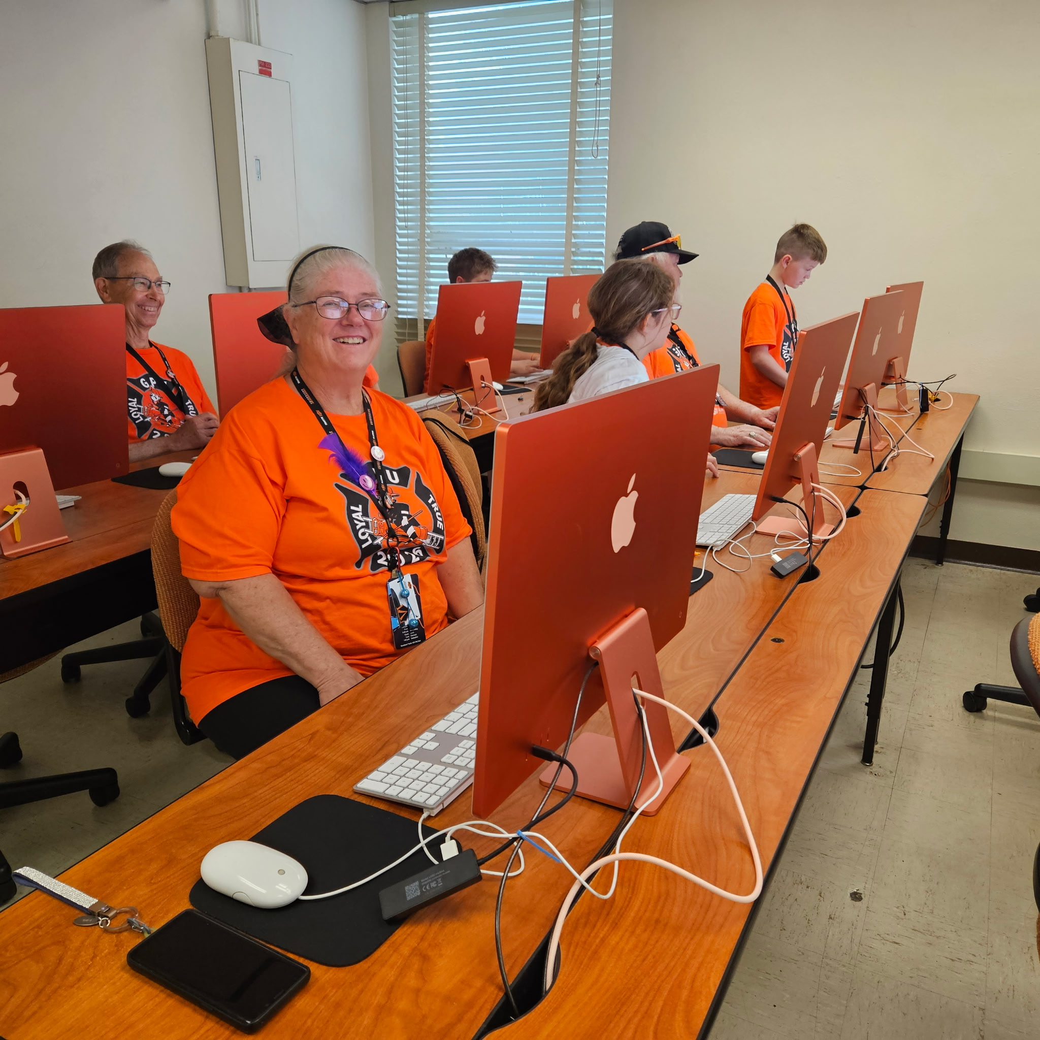Classroom computer lab with students working at desktop computers during class.