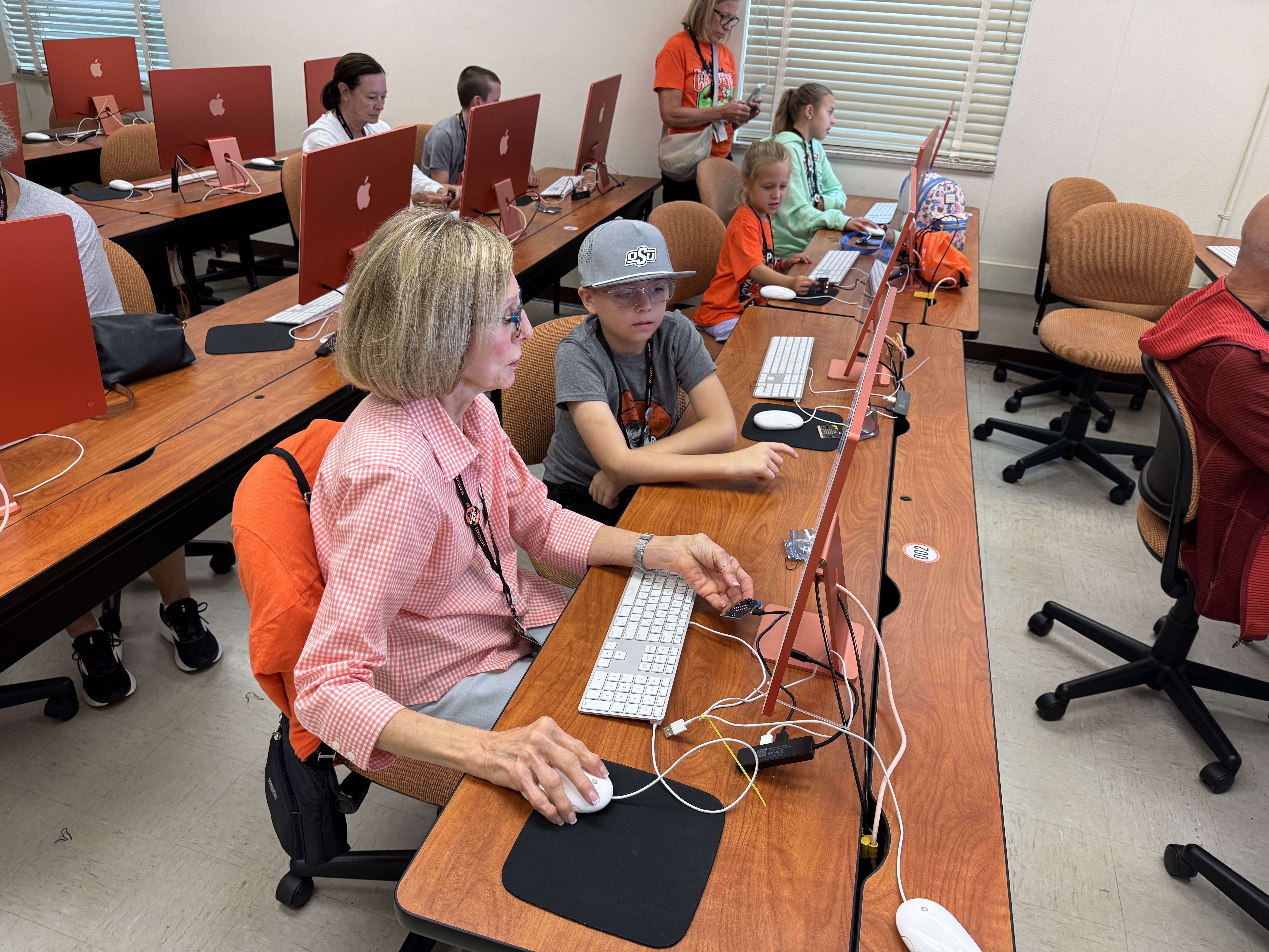 Classroom computer lab with students working at desktop computers during class.