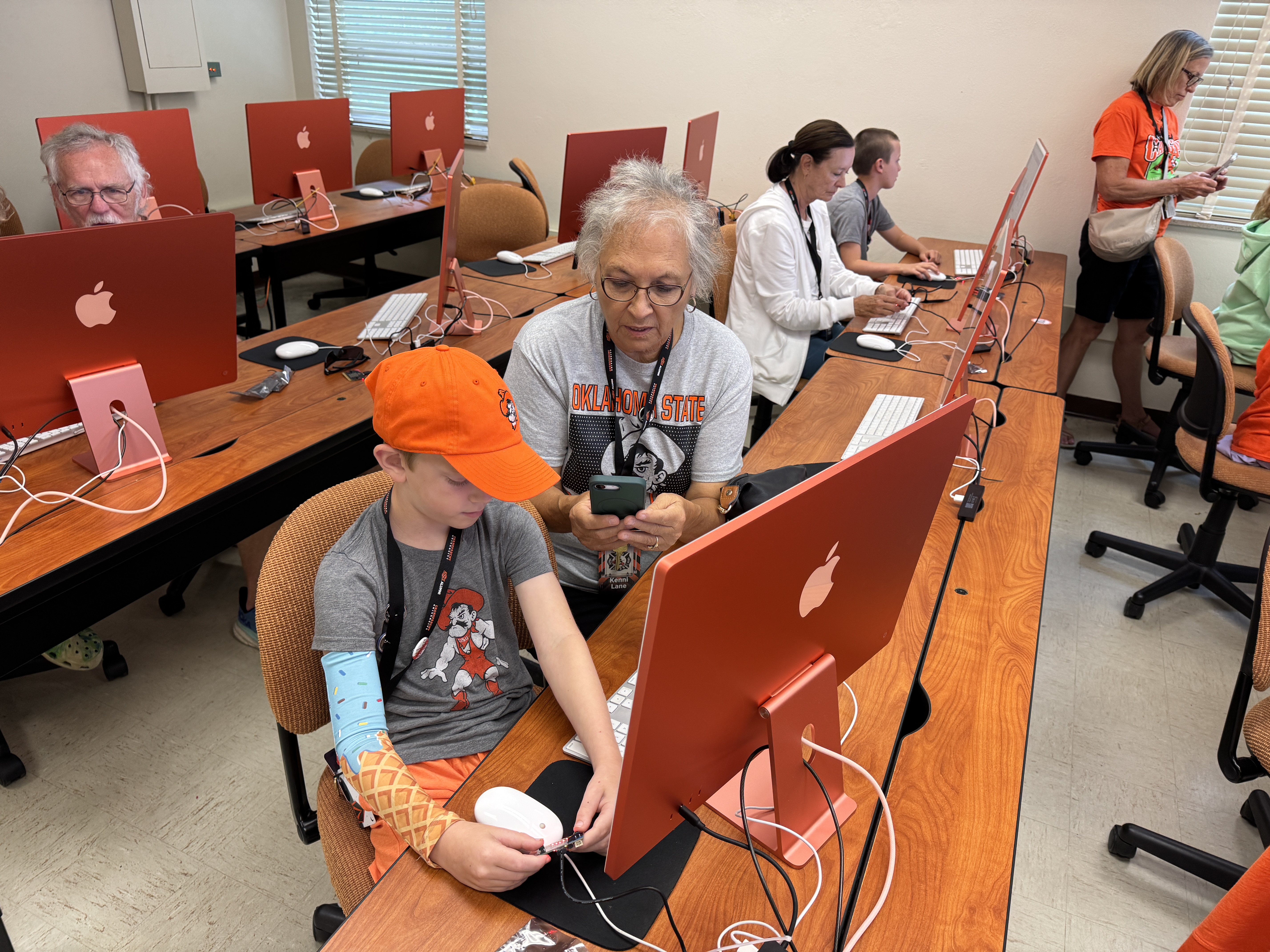 Classroom computer lab with students working at desktop computers during class.