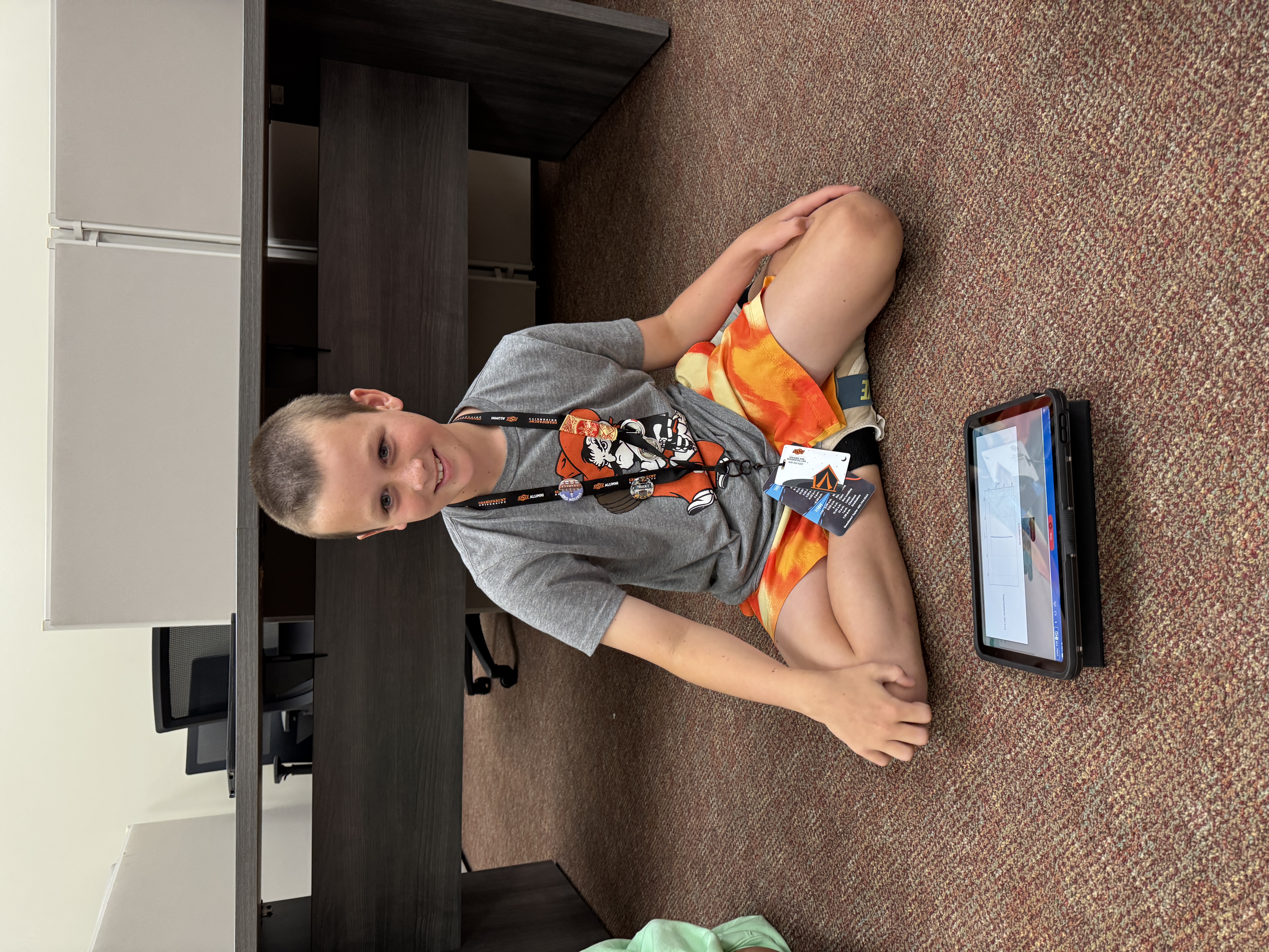 Student sitting on the floor during a class activity.