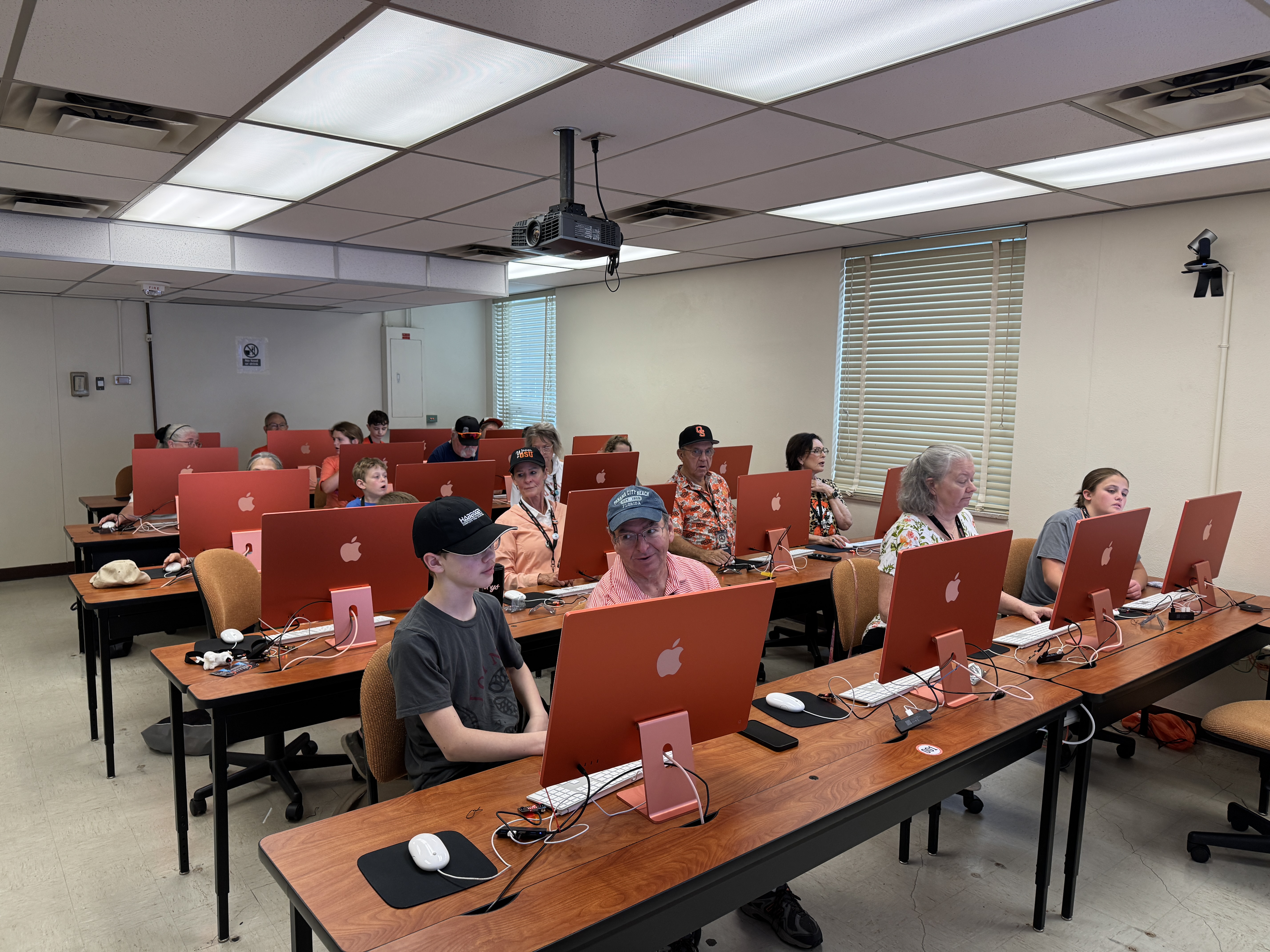 Classroom computer lab with students working at desktop computers during class.