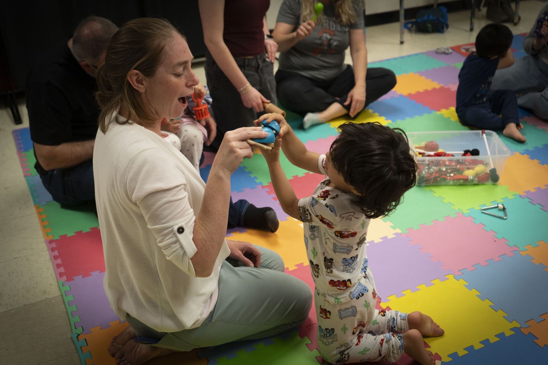 Mother holding a toddler in a music class