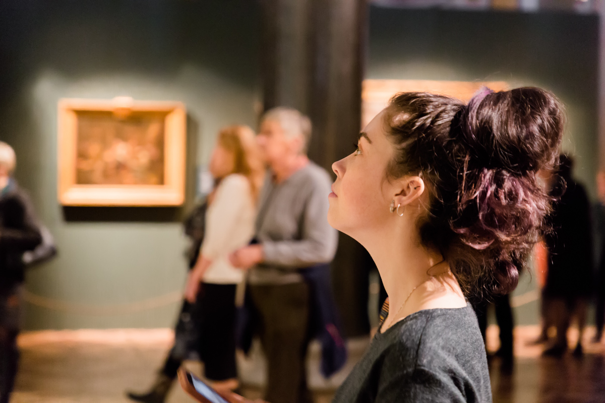 A girl watching a performance in a theater.