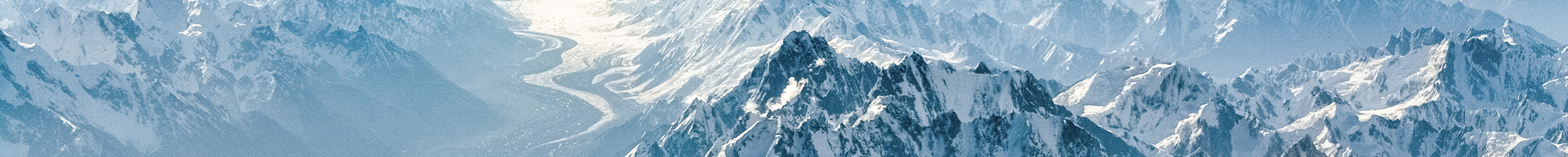 Snow-covered mountain range under a clear blue sky. Snow-covered mountain range under a clear blue sky.