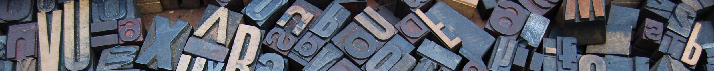 Collection of letterpress printing blocks with raised letters. Collection of letterpress printing blocks with raised letters.